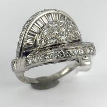 Retro Diamond and Platinum Cocktail Ring; designed as a dome with curved and flaring ridges, set with 2.55 carats round brilliant cut and baguette diamonds