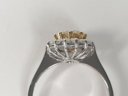 Old Cut Fancy Yellow Diamond Cluster Ring; featuring a 1.28 carat old European transitional cut fancy yellow diamond surrounded by a halo of sparkling white diamonds. Mounted in platinum