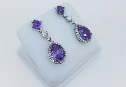 Amethyst and Diamond Pear Shaped Cluster Drop Earrings; pear-shaped rose-cut amethyst and diamond cluster suspended by an amethyst stud, via a brilliant cut diamond. Mounted in 18ct white gold.
