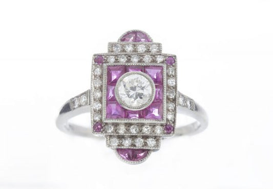 Vintage Art Deco Style Ruby and Diamond Cluster Plaque Ring; central 0.33ct round brilliant-cut diamond surrounded by mixed cut rubies and an outer border of sparkling diamonds. Mounted in 18ct white gold. Circa 1980s