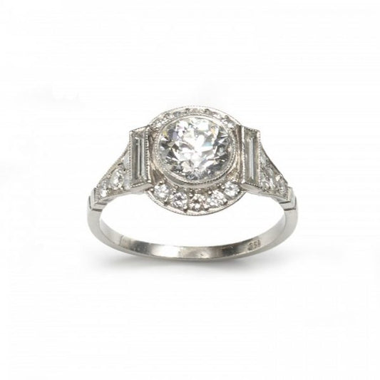 Art Deco Style Diamond Cluster Ring in Platinum; central 1.48ct H colour VS1 clarity round transitional brilliant cut diamond surrounded by a halo of brilliant and baguette cut diamonds, diamond set shoulders