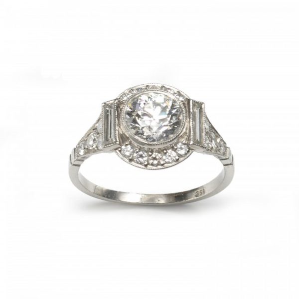 Art Deco Style Diamond Cluster Ring in Platinum; central 1.48ct H colour VS1 clarity round transitional brilliant cut diamond surrounded by a halo of brilliant and baguette cut diamonds, diamond set shoulders