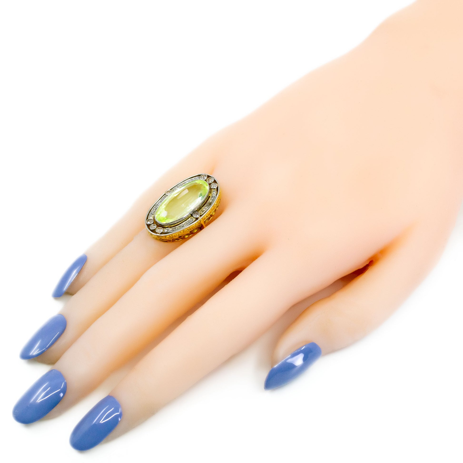 An oval spinel and rose cut diamond Art Deco design cluster dress ring in yellow gold and platinum, modelled on a hand with blue nail polish