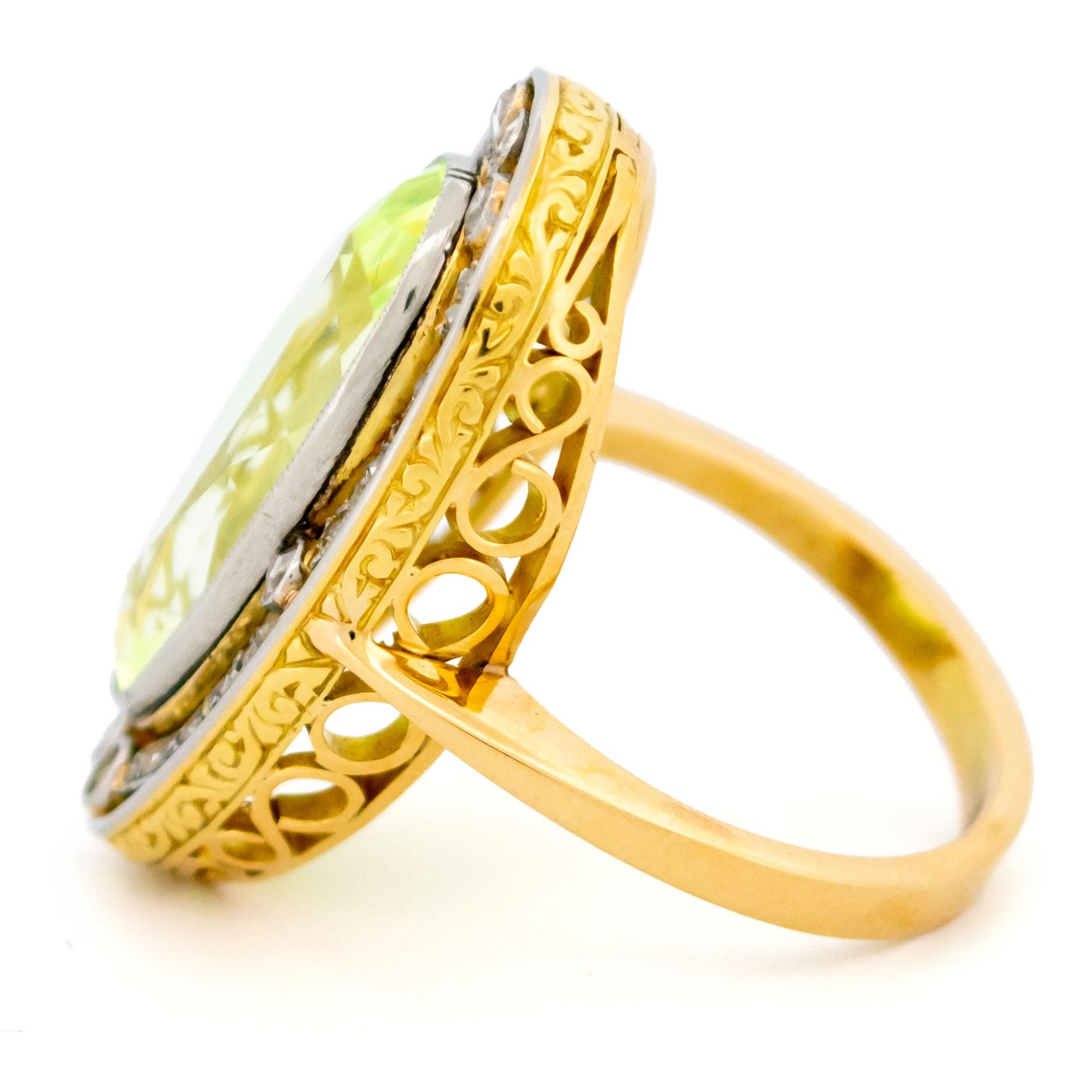 An oval spinel and rose cut diamond Art Deco design cluster dress ring in yellow gold and platinum, with a scrolled gallery, against a white background