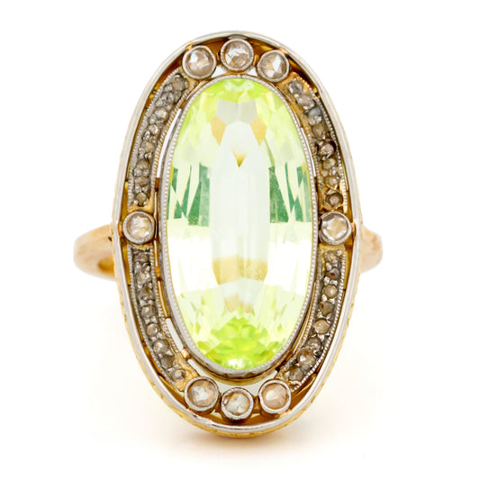 An oval spinel and rose cut diamond Art Deco design cluster dress ring in yellow gold and platinum, against a white background