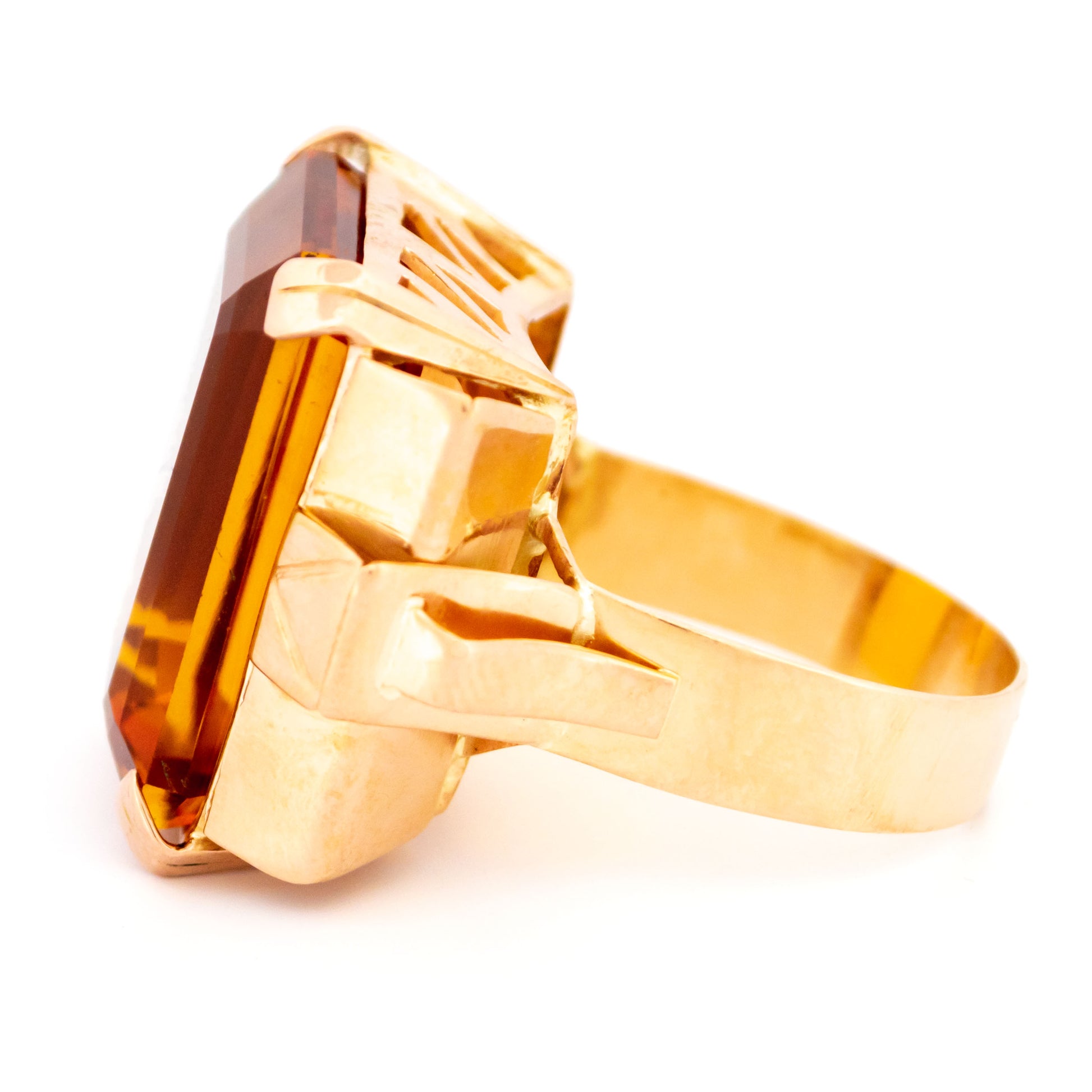 A large citrine solitaire dress ring in yellow gold