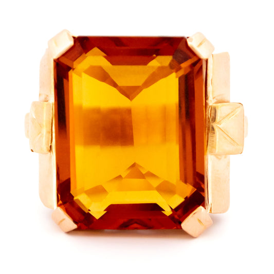 A large citrine solitaire dress ring in yellow gold