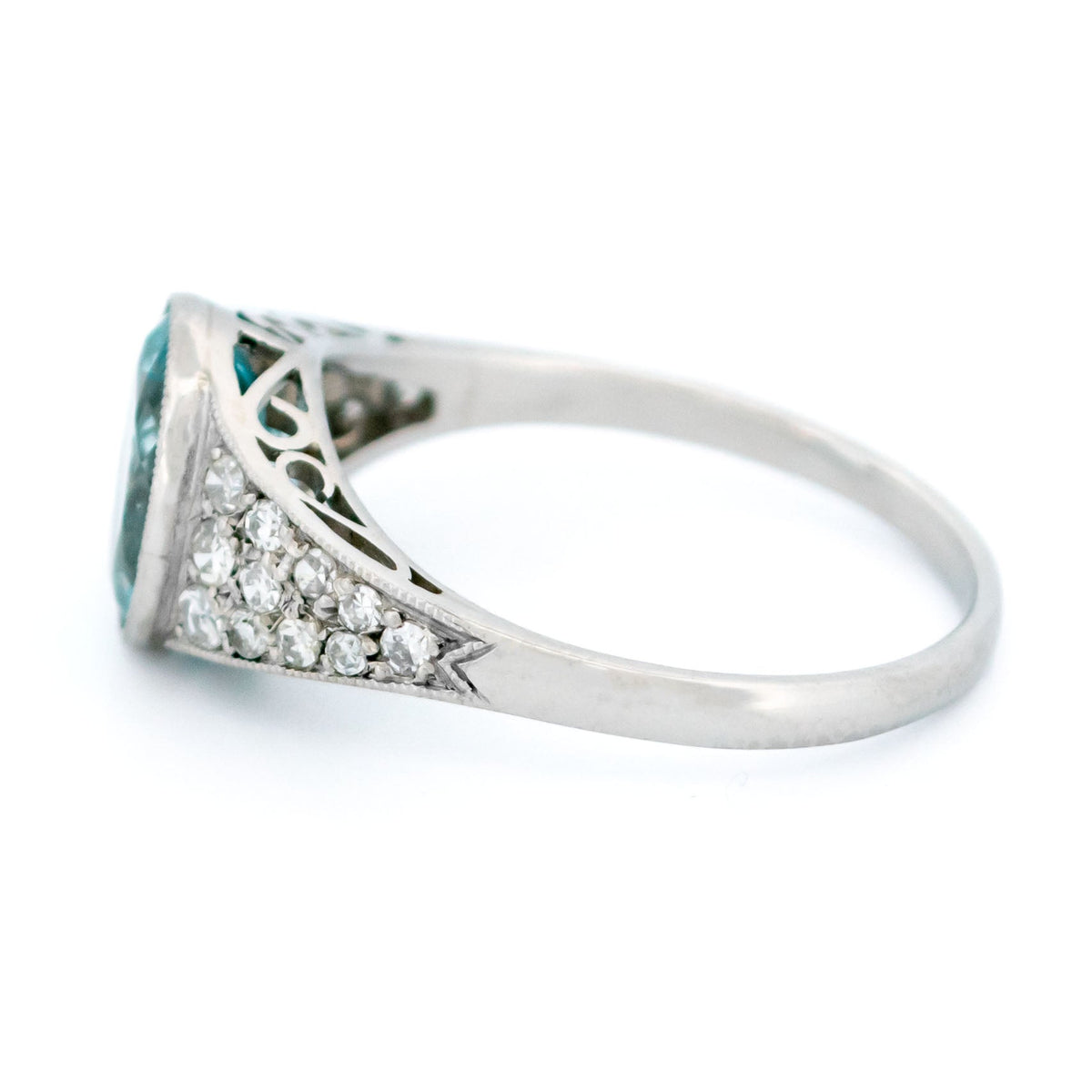 An oval aquamarine ring with graduated driamond shoulders, in platinum