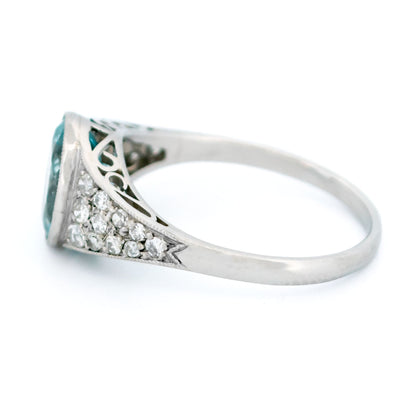 An oval aquamarine ring with graduated driamond shoulders, in platinum