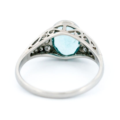 An oval aquamarine ring with graduated driamond shoulders, in platinum