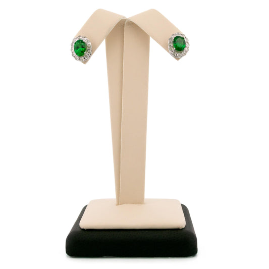 A pair of oval cluster stud earrings with green garnets and white diamonds