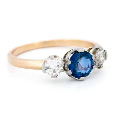 A three stone sapphire and diamond ring in yellow and white gold