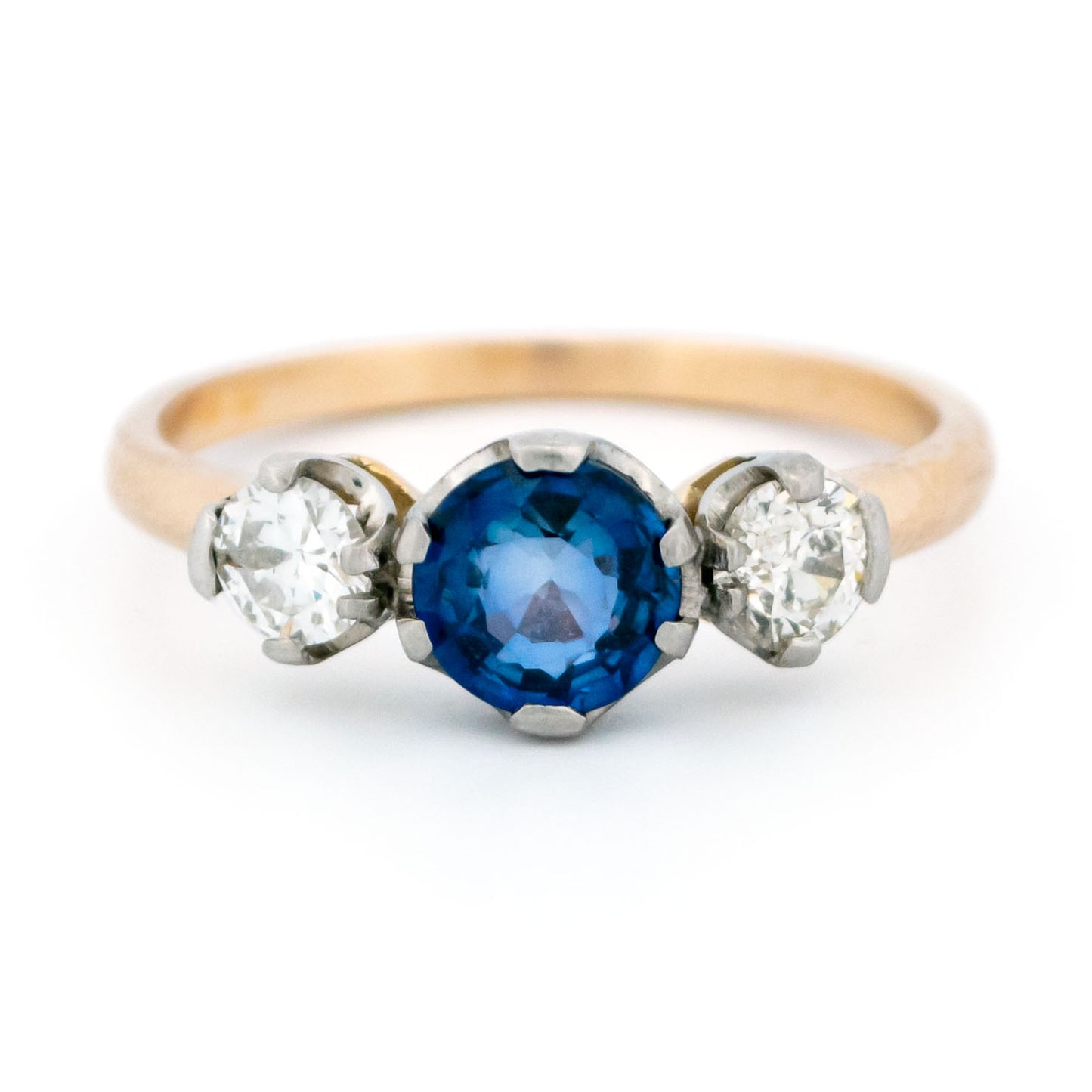 A three stone sapphire and diamond ring in yellow and white gold