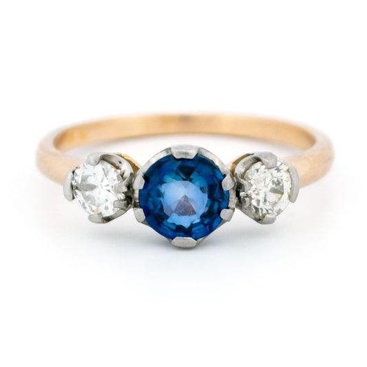 A three stone sapphire and diamond ring in yellow and white gold