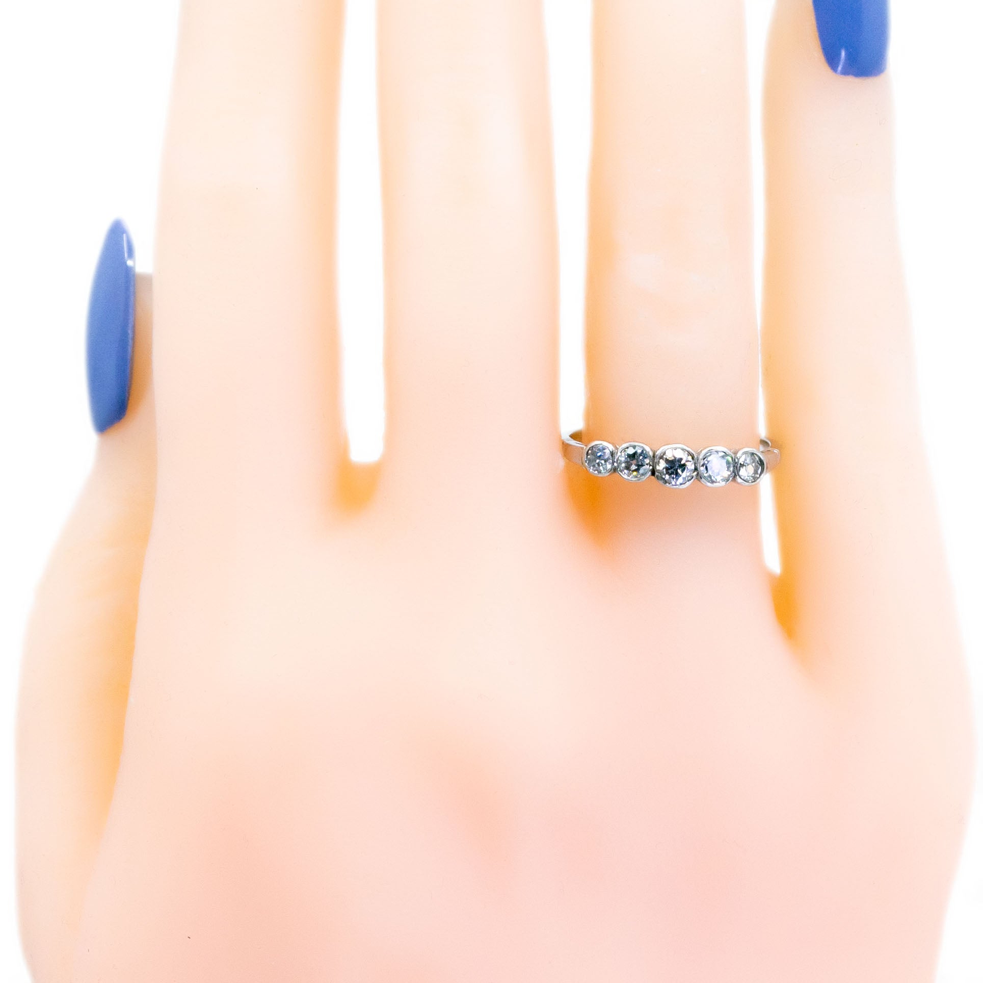 A five stone diamond ring in platinum, modelled on a hand