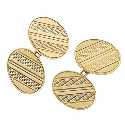 A pair of yellow gold oval shaped cufflinks with engine turned engraving, on a white background