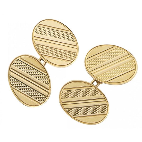 A pair of yellow gold oval shaped cufflinks with engine turned engraving, on a white background
