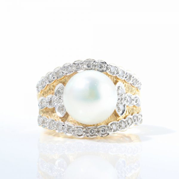 Vintage 1950s Pearl and Diamond Dress Ring; wide 18ct yellow gold cocktail ring set with a central freshwater pearl accented with 0.72cts diamonds. Circa 1950s-1960s