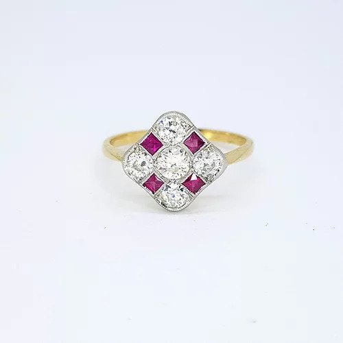 Ruby and Diamond Checkerboard Cluster Ring; five circular diamonds and four square faceted rubies arranged in a diamond-shaped checkerboard design, mounted in platinum to an 18ct yellow gold shank