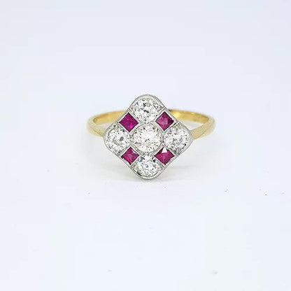 Ruby and Diamond Checkerboard Cluster Ring; five circular diamonds and four square faceted rubies arranged in a diamond-shaped checkerboard design, mounted in platinum to an 18ct yellow gold shank