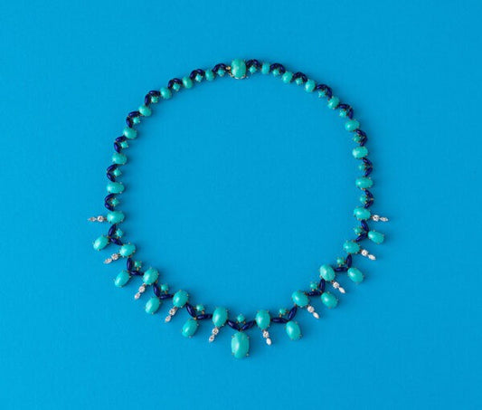 Vintage Turquoise, Diamond and Enamel Fringe Necklace; set with oval and round cabochon cut turquoises, accented with by dark blue translucent enamel leaves and 1.55cts brilliant cut diamonds, in 18ct gold, Circa 1960