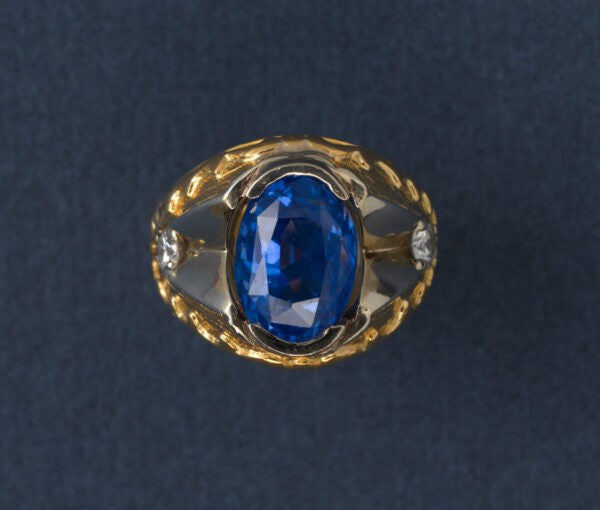 Oval Ceylon Sapphire and Diamond Ring; 11ct oval faceted natural Sri Lanka sapphire, flanked by white gold and diamonds, hammered 22ct yellow gold shank