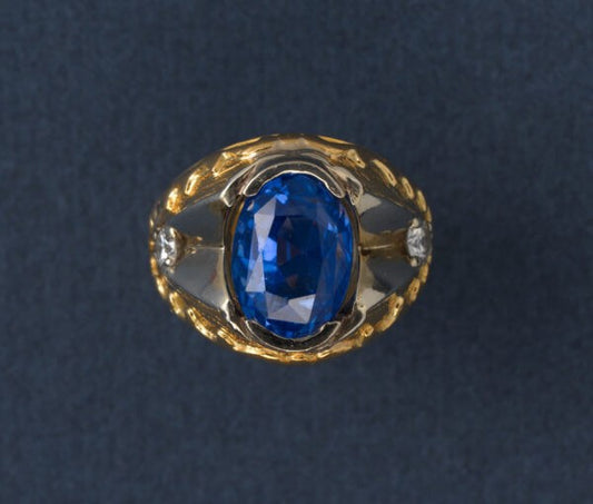 Oval Ceylon Sapphire and Diamond Ring; 11ct oval faceted natural Sri Lanka sapphire, flanked by white gold and diamonds, hammered 22ct yellow gold shank