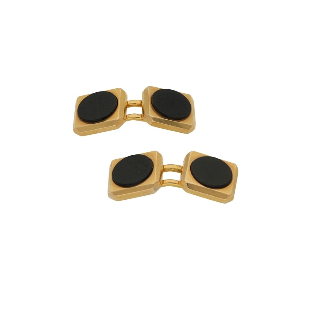 A pair of yellow gold cufflinks with circular black onyx, on a white background
