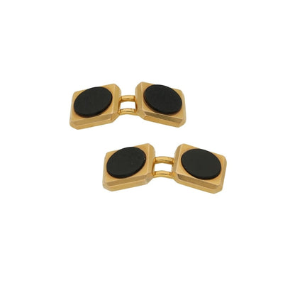 A pair of yellow gold cufflinks with circular black onyx, on a white background
