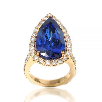 Vintage Pear Cut Tanzanite and Diamond Cluster Ring; 12 carat pear-shaped faceted natural tanzanite surrounded by 2.50cts diamonds, in 18ct yellow gold. Circa 1970s. Comes with GCS certificate