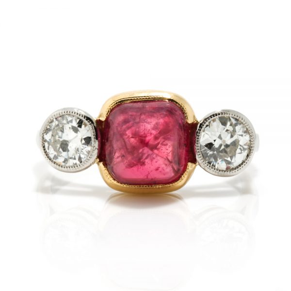 Art Deco Natural Cabochon Ruby and Diamond Trilogy Ring; central 4.52ct cabochon-cut natural ruby flanked by 1cts old-cut diamonds, in 18ct yellow gold and platinum, Circa 1920, with GCS certificate