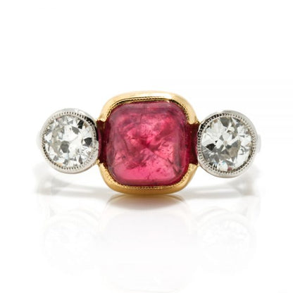 Art Deco Natural Cabochon Ruby and Diamond Trilogy Ring; central 4.52ct cabochon-cut natural ruby flanked by 1cts old-cut diamonds, in 18ct yellow gold and platinum, Circa 1920, with GCS certificate