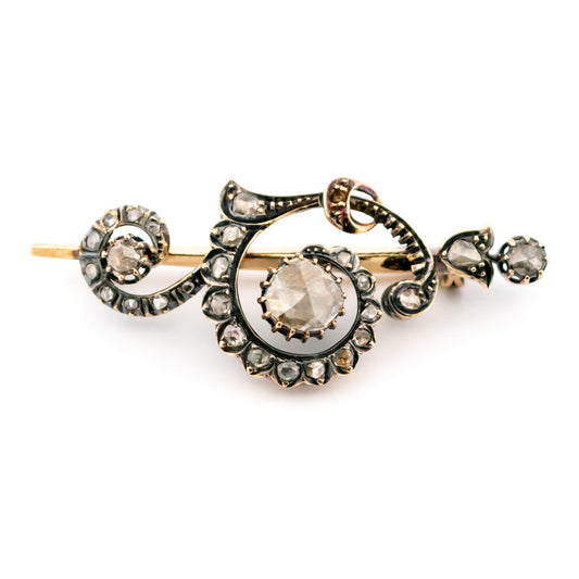 A rose-cut diamond scroll design brooch in gold and silver