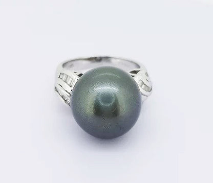 Grey South Sea Pearl and Diamond Ring; A striking 13mm grey South Sea pearl accented with diamond set shoulders. Mounted in 18ct white gold.