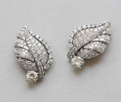 Art Deco Diamond Set Leaf Earrings; pair of platinum and white gold earrings in the shape of leaves set with 5cts baguette and brilliant-cut diamonds