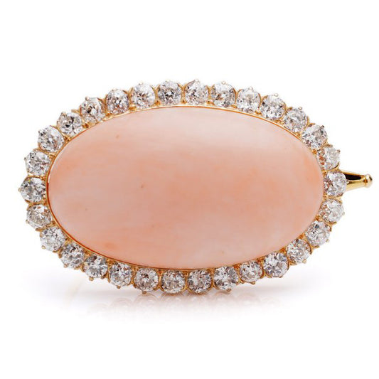 Antique Angel Skin Coral and Old Cut Diamond Cluster Brooch by Leitão & Irmão, large oval cabochon angel skin coral set within a surround of 4.50cts old cut diamonds in 18ct yellow gold