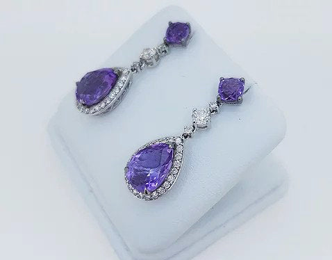 Amethyst and Diamond Pear Shaped Cluster Drop Earrings; pear-shaped rose-cut amethyst and diamond cluster suspended by an amethyst stud, via a brilliant cut diamond. Mounted in 18ct white gold.