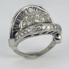 Retro Diamond and Platinum Cocktail Ring; designed as a dome with curved and flaring ridges, set with 2.55 carats round brilliant cut and baguette diamonds