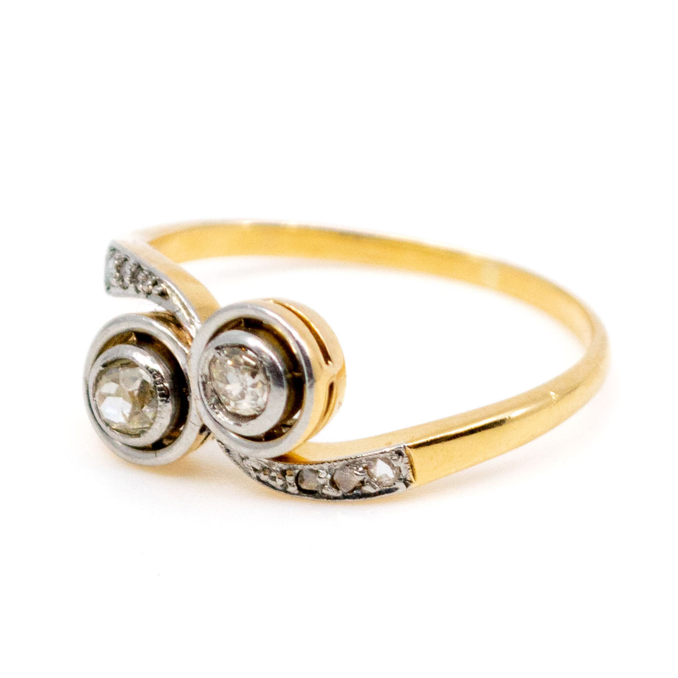 A two stone diamond crossover ring in yellow and white gold
