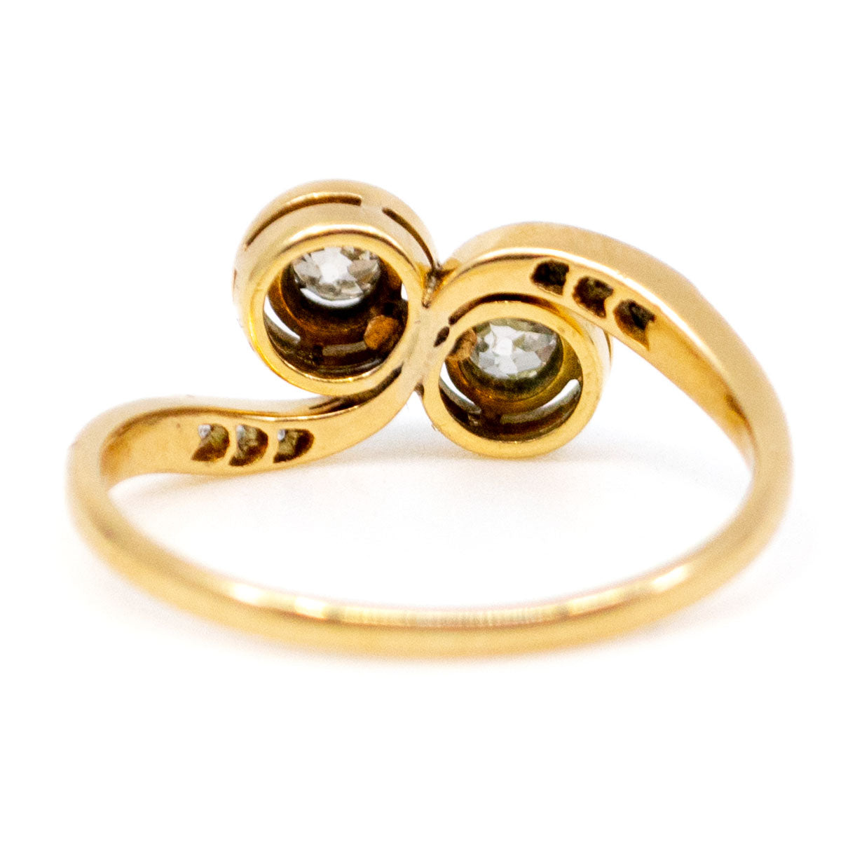A two stone diamond crossover ring in yellow and white gold