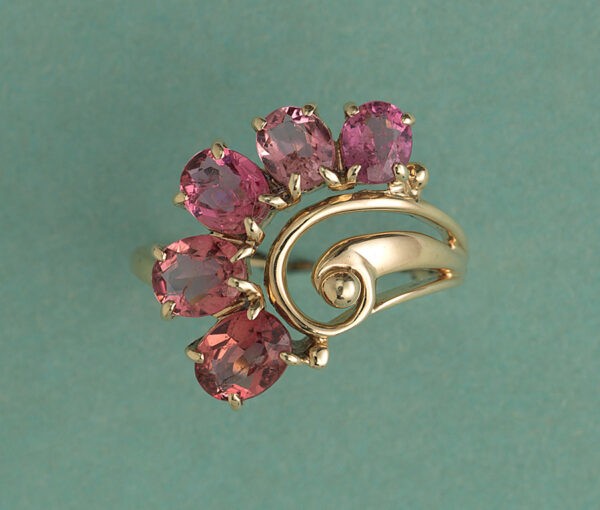 Vintage Pink Tourmaline and 18ct Yellow Gold Flower Ring; set with five oval faceted pink tourmalines beautifully graduating in size and colour, Circa 1950