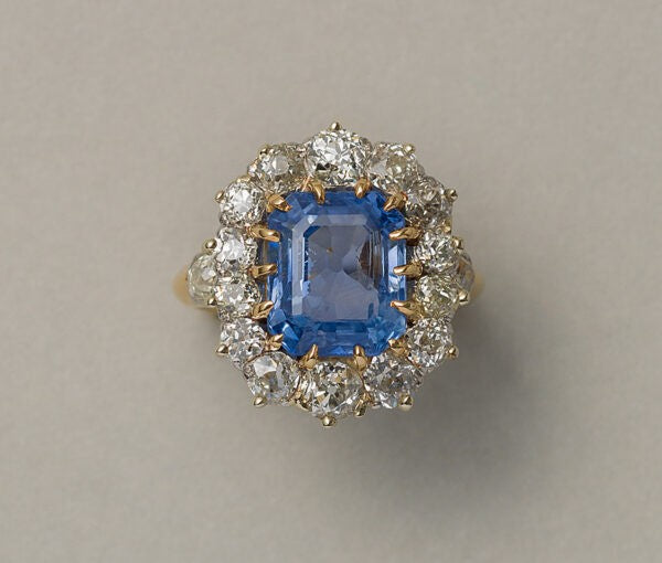Art Nouveau French 5.13ct Sri Lanka Sapphire and Old Cut Diamond Cluster Ring; 5.13 carat emerald-cut light-blue unenhanced Sri Lanka sapphire set within an 1.50ct old-cut diamond surround in 18ct yellow gold, Circa 1900