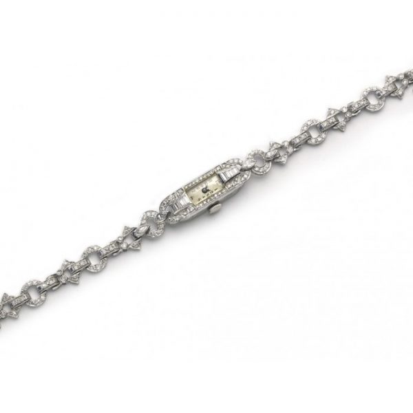Art Deco Diamond and Platinum Cocktail Wristwatch; set with 6.00 carats of marquise, baguette and eight-cut diamonds to the case and bracelet, Circa 1925