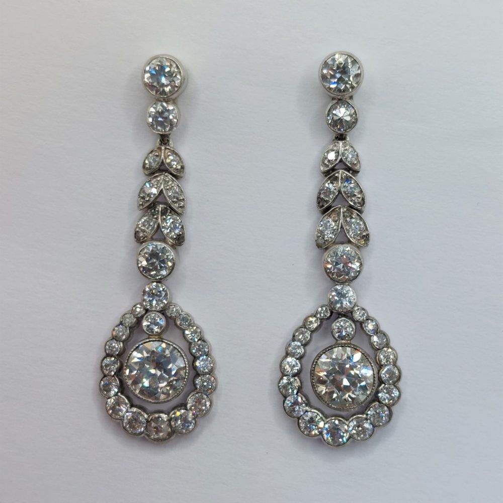 Antique Belle Epoque 3ct Old Cut Diamond Drop Earrings; set with 3.10 carats of old cut diamonds in a delicate cluster and leaf articulated design in Platinum. Circa 1900