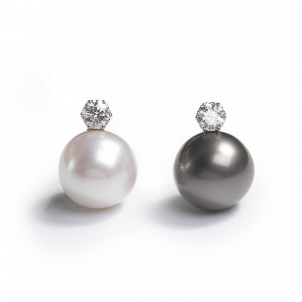 South Sea Pearl and Diamond Earrings; one black and one white South Sea cultured pearl, each topped with a round brilliant-cut diamond, 2.20 carat total, in white gold