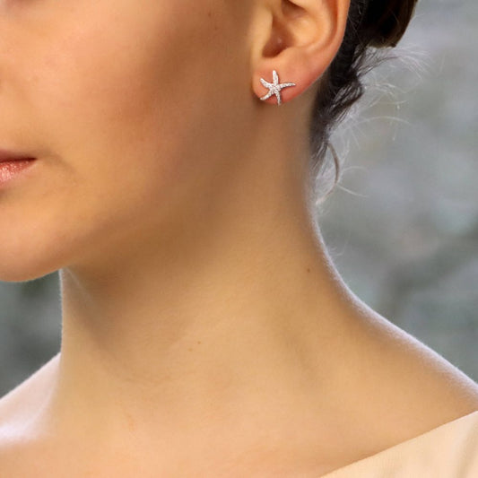 Diamond starfish stud earrings in white gold.