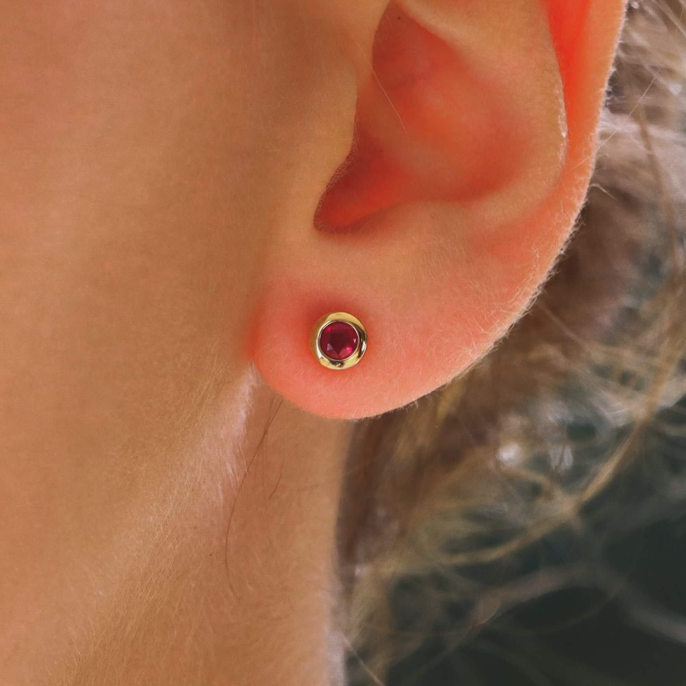 Ruby stud earrings set in 18 carat yellow gold.