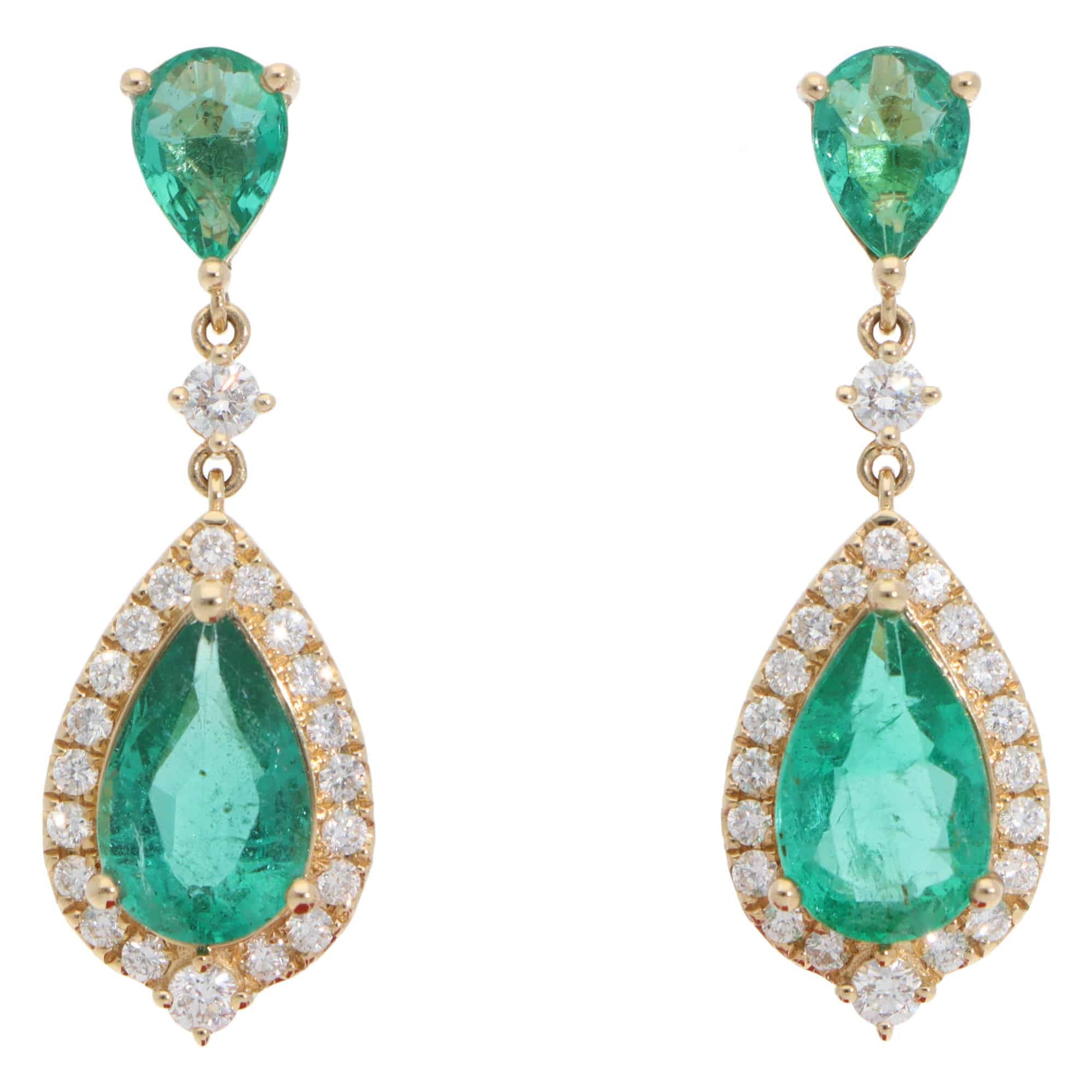 A pair of emerald and diamond cluster drop earrings in yellow gold, on a white background