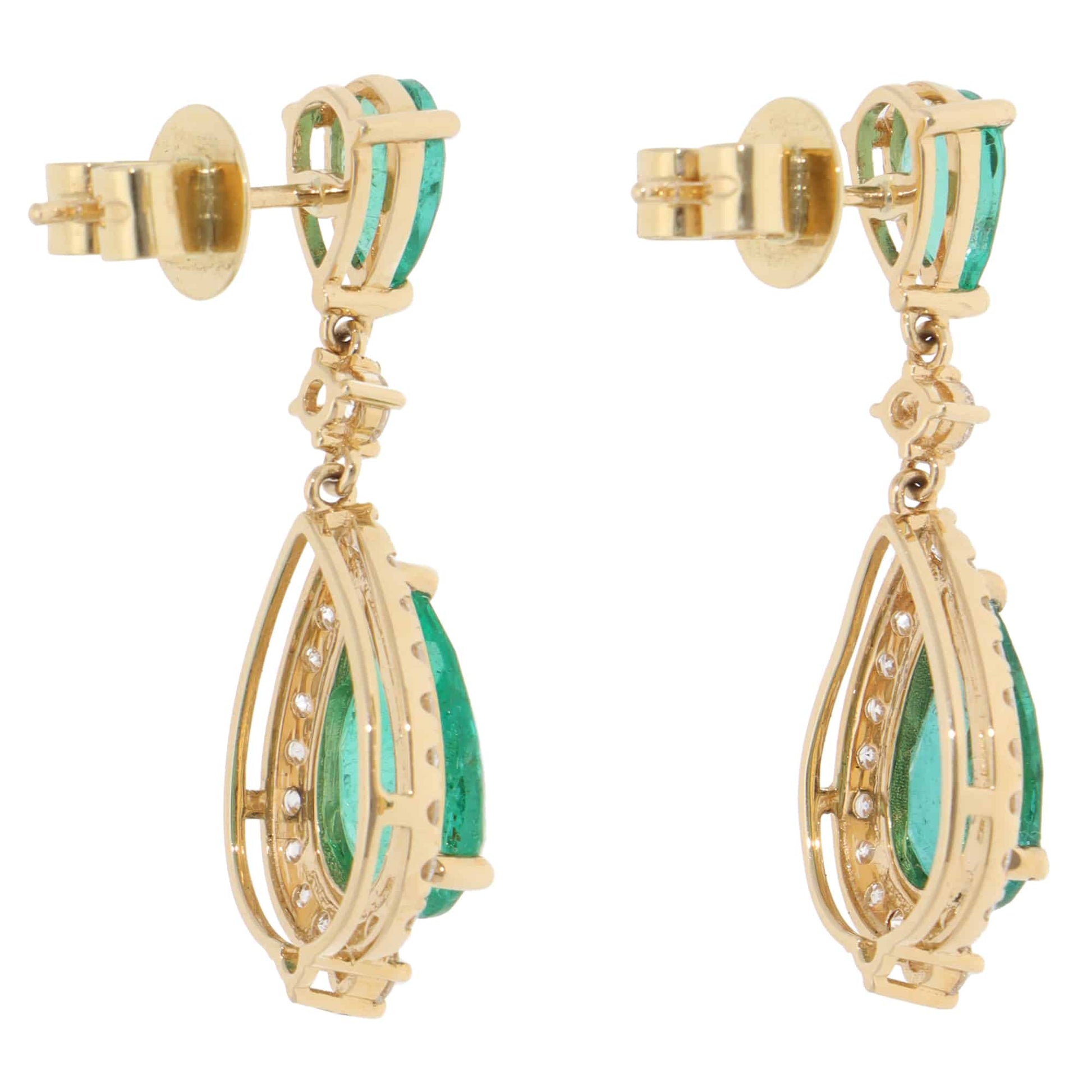A pair of emerald and diamond cluster drop earrings in yellow gold, on a white background