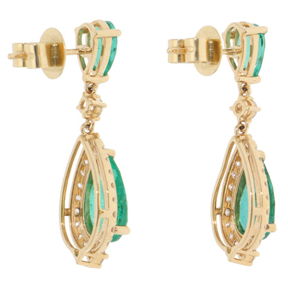 A pair of emerald and diamond cluster drop earrings in yellow gold, on a white background